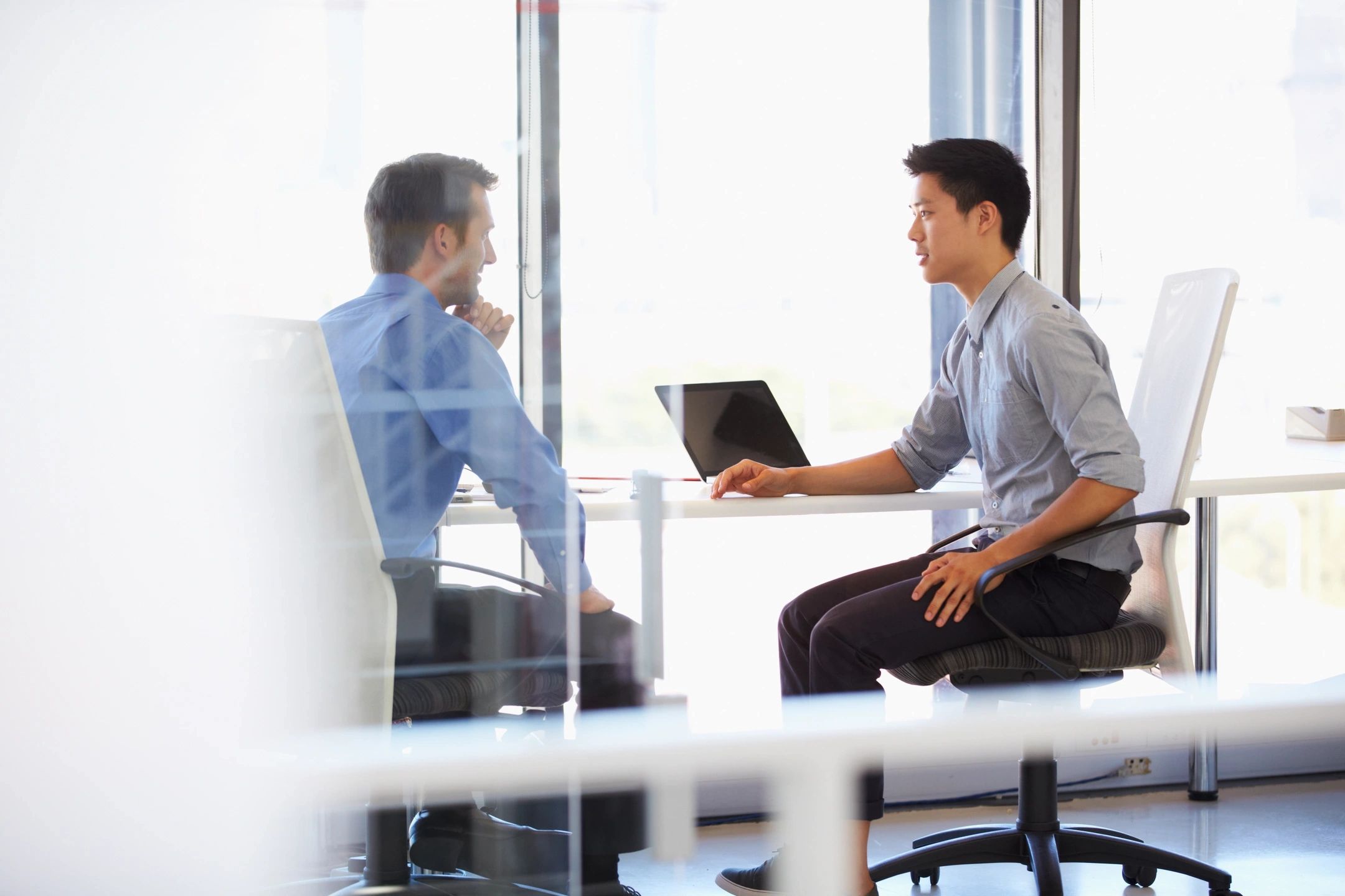 Two men talking in modern office